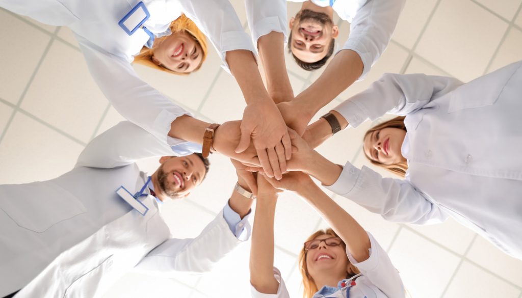 Team,Of,Doctors,Putting,Hands,Together,,Bottom,View